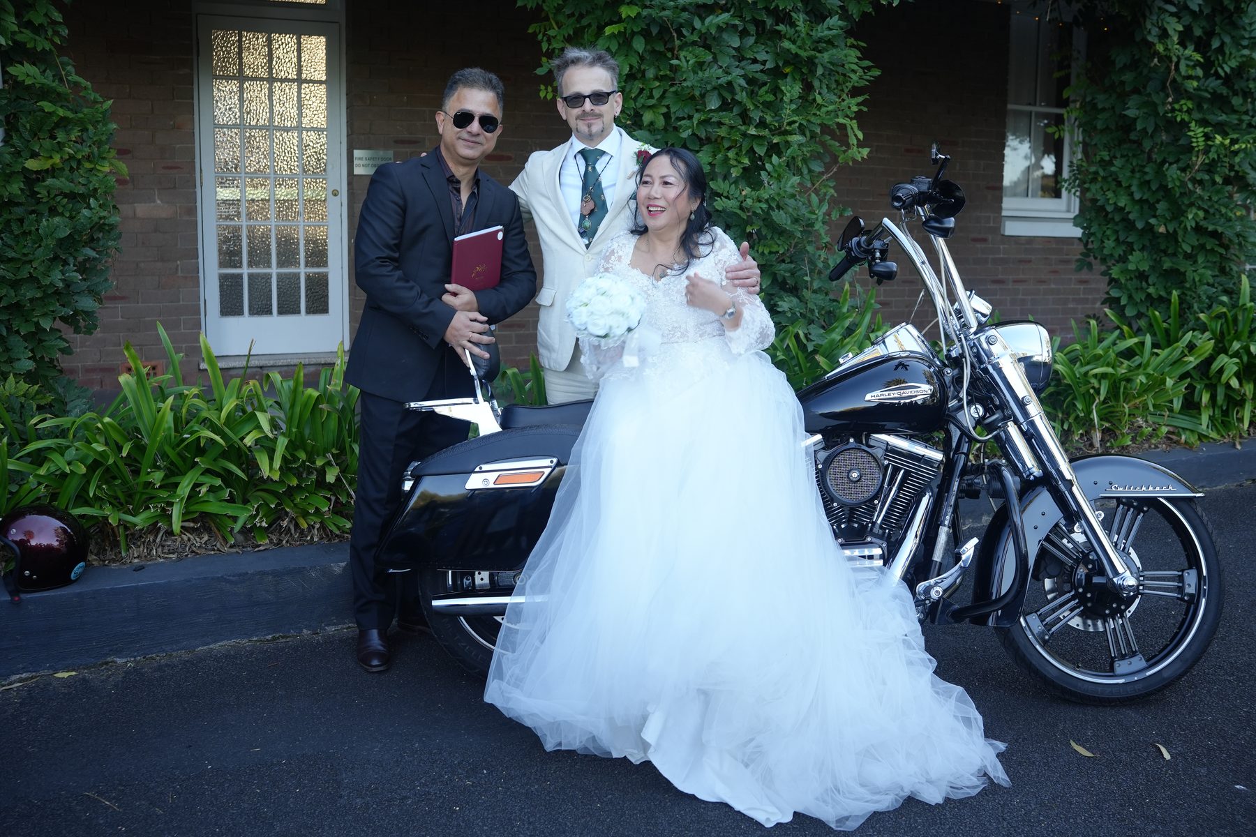 Newlyweds beside a Harley-Davidson after their Sydney ceremony